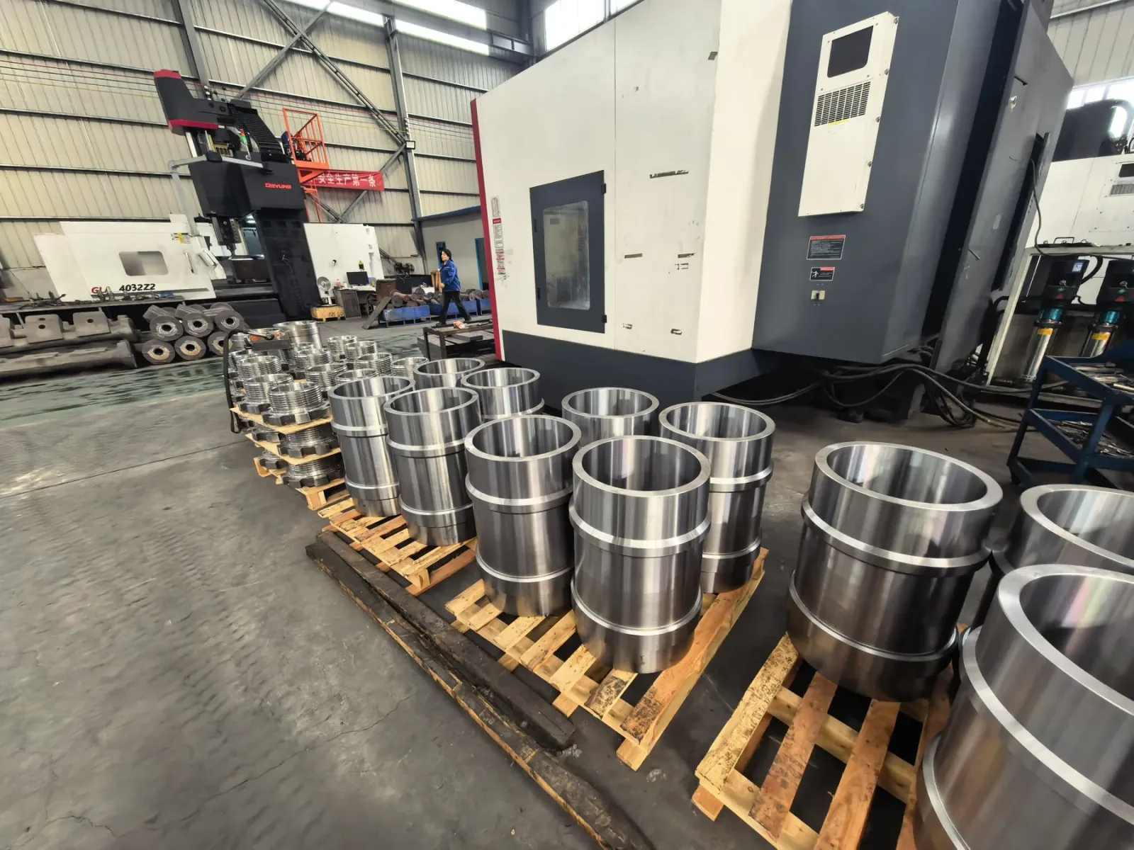 Machined titanium rings arranged alongside CNC equipment