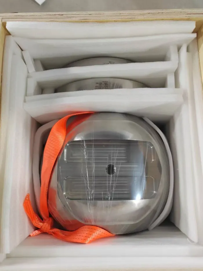 A machined titanium component secured inside a wooden export case