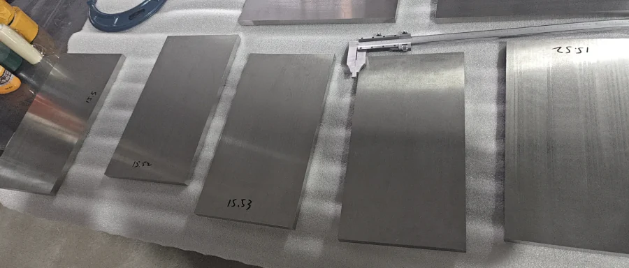 Cut titanium plate blanks laid out for dimensional review