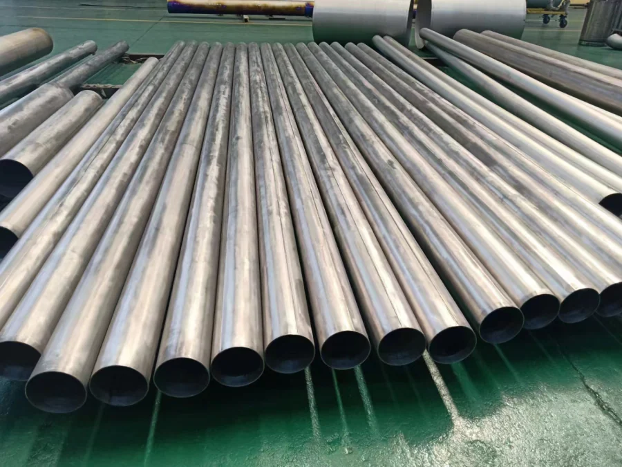 Open-ended titanium tubes photographed on a workshop floor