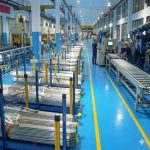Modern titanium tubing production line with 1.5 inch tubes organized on racks in clean factory workshop for industrial applications