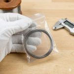 Small coil of thin titanium wire in protective packaging, highlighting quality control and careful handling by Beiyu Titanium