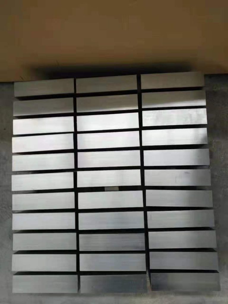 Rectangular titanium cut blanks arranged in rows before machining