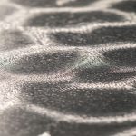 Close-up surface detail of precision titanium build plate showing optimized texture for strong powder adhesion in 3D printing