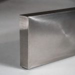 Side view of titanium build plate showing precise thickness and clean machined edges for metal additive manufacturing