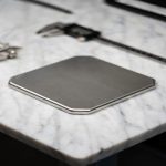 Titanium build plate on marble inspection platform verifying high flatness and precision quality for 3D printing