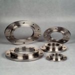 Side view of a thick forged titanium flange highlighting its robust construction and smooth machined surfaces