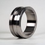 Forged titanium ring with a machined outside diameter, standing on edge