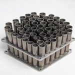 Close-up of titanium tube bundle and tube sheet in shell and tube heat exchanger, precision arranged titanium tubes, high performance heat transfer design