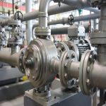 Compact magnetic drive titanium pump (ITM series) mounted on stainless steel base in industrial setting, highlighting zero-leakage sealed design