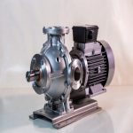 Titanium submersible pump partially submerged in liquid, showing robust titanium motor housing and impeller designed for corrosive media handling