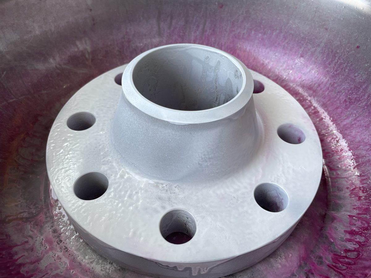 Grade 12 titanium weld neck flange during PT inspection after developer application