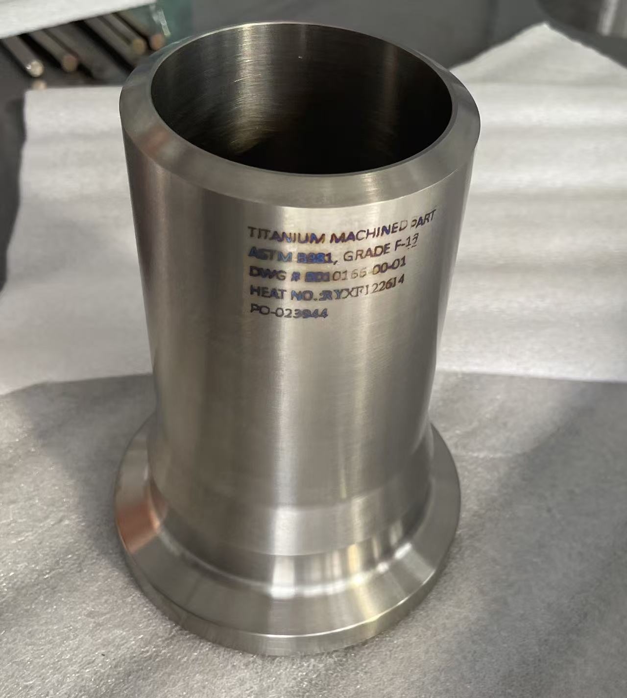 Titanium machined part marked ASTM B381 Grade 12 with drawing and heat number