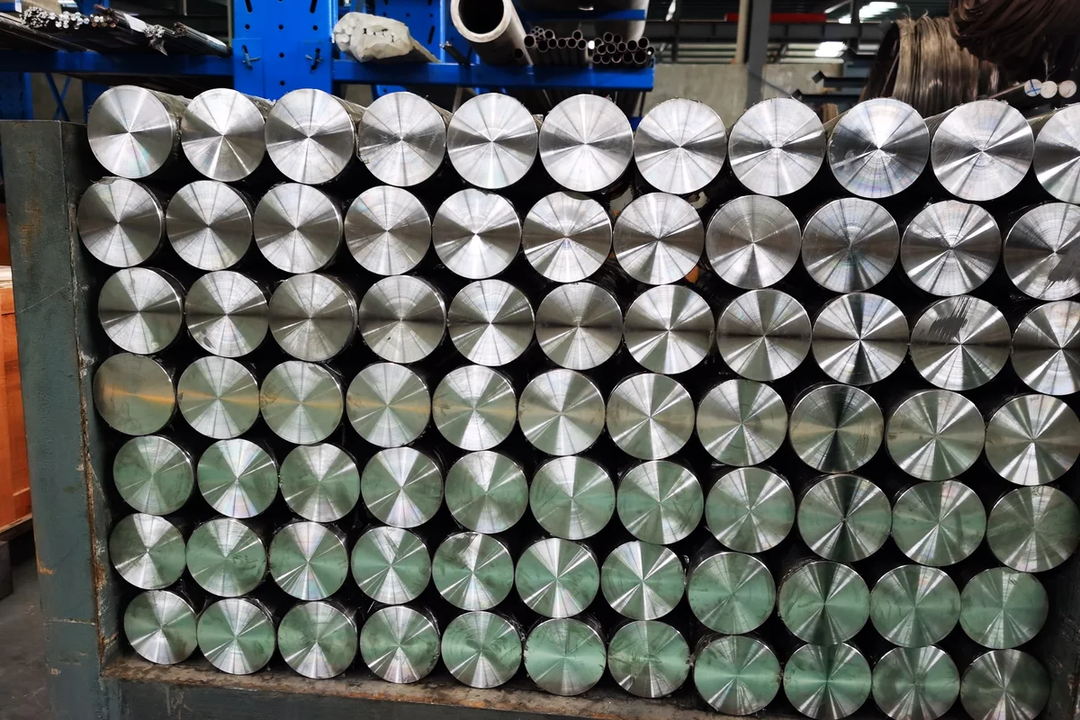 Titanium round bar cut to length and stood on end, cut faces visible before end preparation