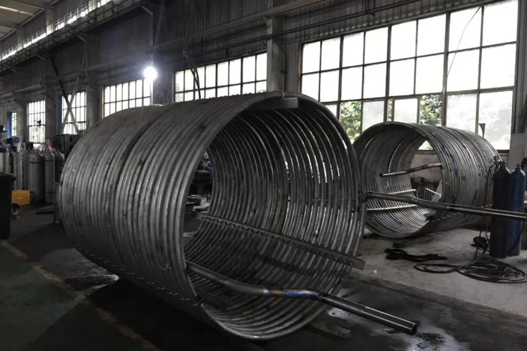 Titanium heat exchanger coils in the workshop for corrosive process service