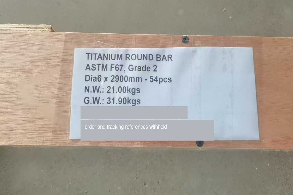 Package marking on a titanium round bar shipment reading TITANIUM ROUND BAR, ASTM F67 Grade 2, Dia6 x 2900mm, 54 pieces