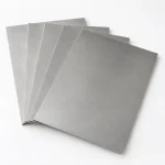 Titanium sheets fanned to show the separate layers, illustrative studio image of the product form