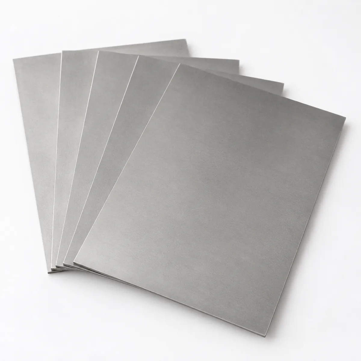 Titanium sheets fanned to show the separate layers, illustrative studio image of the product form