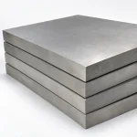 Stack of heavy titanium plate showing the thick cut edges, illustrative studio image of the product form