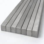 Titanium square bar in a parallel stack with the solid square cross sections facing the camera, illustrative studio image of the product form